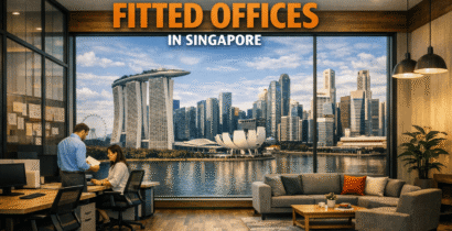 Modern office with two people working, large windows overlooking the Singapore skyline, and the text “Why More Companies Singapore Choose Fitted Offices in Singapore.”.