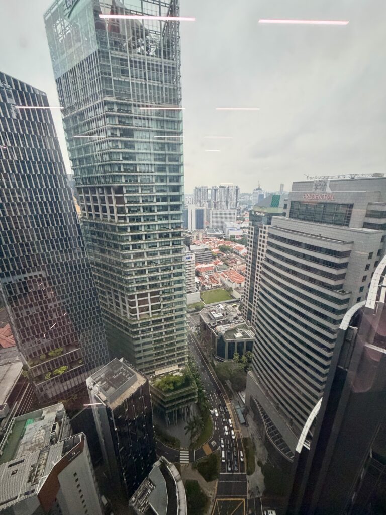 High-angle view of dense city skyscrapers, including the Prudential building, overlooking a street with light traffic.