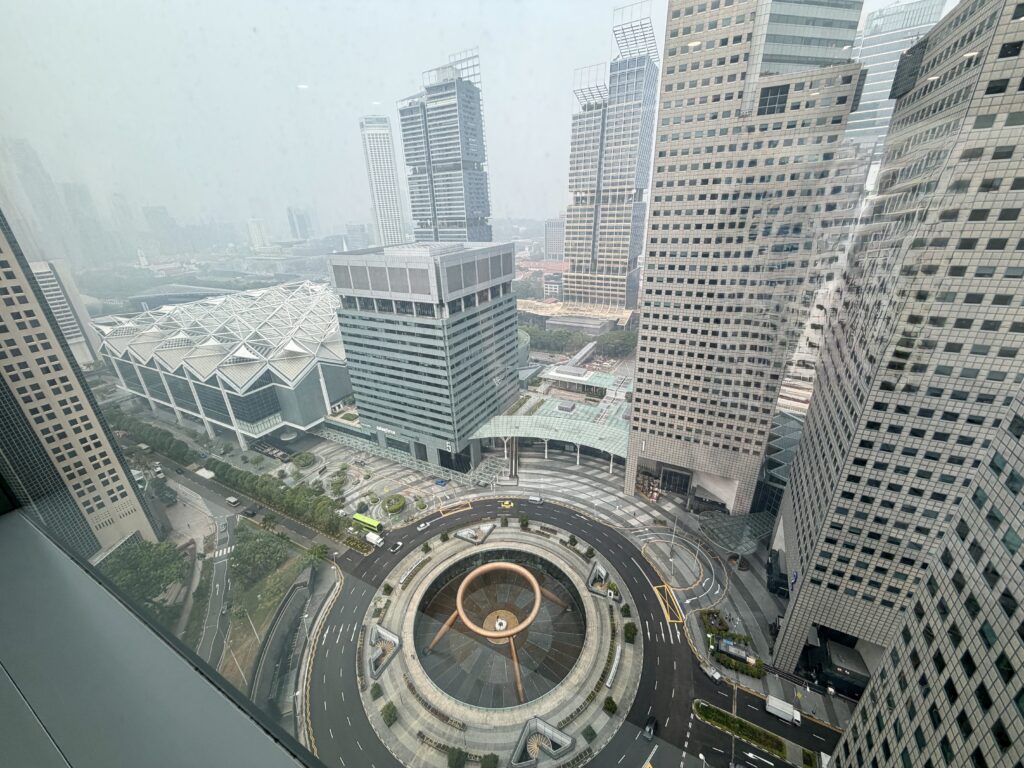 An elevated view of the Suntec City fountain and surrounding skyscrapers in Singapore.